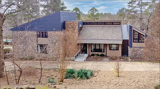  ?? SUBMITTED PHOTOS ?? This four-bedroom, five-and-a-half-bath home in Little Rock provides a sauna, tall ceilings, an indoor koi pond, a wood-burning fireplace and an abundance of natural light.