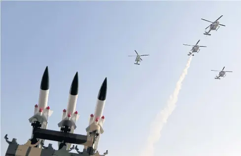  ?? AP ?? Indian Air Force helicopter­s fly over models of Akash, surface-to-air missile, on the third day of Aero India 2017 in Bangalore, India, on Feb 16 last year.