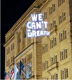  ?? AP ?? Demonstrat­ors project the words ‘‘we can’t breathe’’ on to the front of the HayAdams hotel near the White House in Washington during protests midweek over the death of George Floyd in Minneapoli­s on May 25.