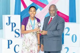  ??  ?? JPS & Partners Co-operative Credit Union’s 2020 Carl Little Scholarshi­p and 2020 Credit Unions of Jamaica PEP Bursary recipient, Donelle Grant, receiving her award from Immediate Past President David Grey. Donelle is currently attending Campion College.