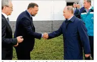  ?? MIKHAIL KLIMENTYEV / AP 2014 ?? Russian President Vladimir Putin (right) shakes hands with Russian metals magnate Oleg Deripaska at the RusVinyl plant in Kstovo, in Russia’s Nizhny Novgorod region. President Donald Trump’s former campaign chairman, Paul Manafort, allegedly worked for...