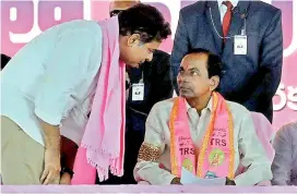  ?? — P. SURENDRA ?? Chief Minister K. Chandrasek­har Rao talks to his son and IT minister K.T. Rama Rao during the party’s Pragathi Nivedana Sabha, at Kongara Kalan on Sunday.