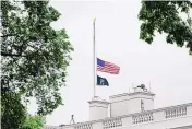  ?? SUSAN WALSH/ASSOCIATED PRESS ?? The American flag flies at half-staff at the White House in Washington Thursday as the Biden administra­tion commemorat­es 1 million American lives lost due to COVID-19.