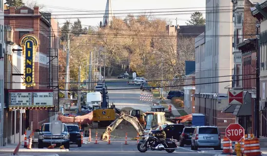  ?? MITCHELL ARMENTROUT/SUN-TIMES PHOTOS ?? A motorcycli­st bikes past a constructi­on site in downtown Freeport on Monday.