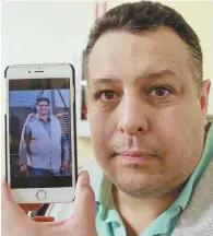  ?? STAFF PHOTO BY MATT WEST ?? ANOTHER DEATH: Angel Serrano holds a phone with a picture of his father, Geraldo Serrano, who was killed in 2010 in a store where Andres Cruz’s widow was also working.