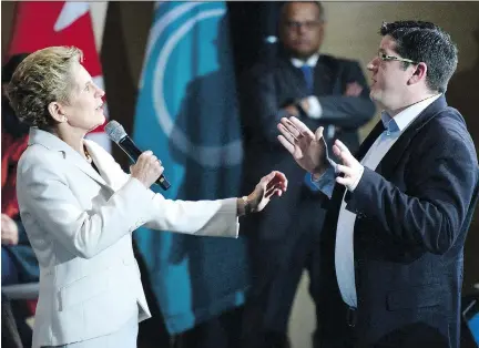  ?? TANG/THE CANADIAN PRESS JUSTIN ?? Will Hickie, a member of the audience, interrupts Premier Kathleen Wynne to ask a question during a town hall meeting in Ottawa on Thursday.