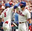  ?? CHRIS SZAGOLA – THE ASSOCIATED PRESS ?? Bryce Harper, left, has a long overdue high-bicep celebratio­n with Rhys Hoskins after Harper’s first-inning home run Sunday against the Braves at Citizens Bank Park.