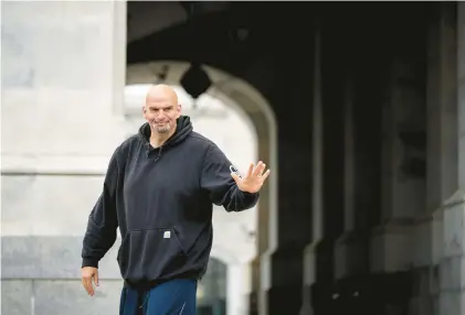  ?? DREW ANGERER/GETTY ?? U.S. Sen. John Fetterman, D-Pa., waves to reporters as he arrives at the U.S. Capitol on April 17 in Washington, D.C. Fetterman returned to the Senate following six weeks of treatment for clinical depression.