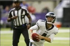  ?? JIM MONE — THE ASSOCIATED PRESS ?? Philadelph­ia Eagles kicker Jake Elliott looks to pass on a fake field goal attempt during the first half of Sunday’s 38-20loss to the Minnestoga Vikings. The trick play failed when Elliott’s pass was tipped and picked off.