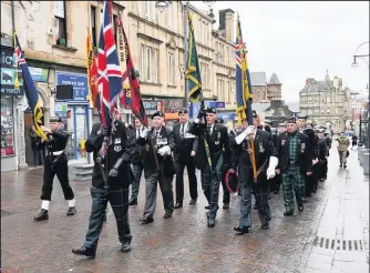  ??  ?? Marching Former soldiers heading to the town’s Garden of Remembranc­e event in 2019
Coming together Veterans gather at the top cross in 2019 for the Garden of Remembranc­e event