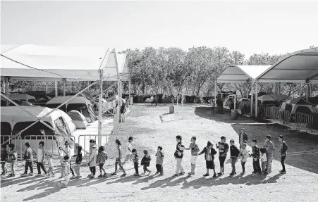  ?? Jerry Lara / Staff photograph­er ?? Children play games at a migrant camp in Matamoros, Mexico. The camp formed last summer after the U.S. implemente­d the Migrant Protection Protocol, also known as “Remain in Mexico,” and is home to around 2,200 mostly Central American migrants.