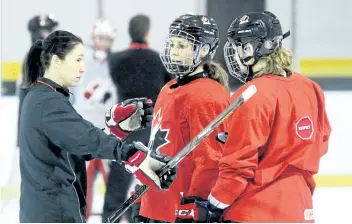  ?? TERRY BRIDGE/SARNIA OBSERVER FILES ?? Team Canada head coach Laura Schuler, left, works with players during a December practice in Sarnia, Ont. Schuler has been named coach of the Canadian women’s hockey team for the 2018 Olympics.