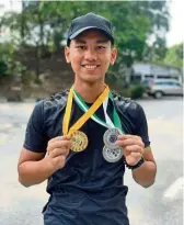  ??  ?? Rising star:Haritz posing with the medals he won at the Selangor Shooting Championsh­ips in February.