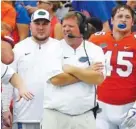  ?? ASSOCIATED PRESS PHOTOS ?? Florida football coach Jim McElwain, center, looks on during the Gators’ 38-24 home win against Vanderbilt this past Saturday. Florida hasn’t been very entertaini­ng lately — in more ways than one — writes columnist Jay Greeson.