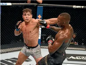  ??  ?? Blood drips from the eye of Paulo Costa shortly before he was stopped by Israel Adesanya during their middleweig­ht championsh­ip fight in Abu Dhabi.