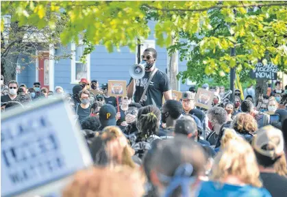  ?? STU NEATBY/THE GUARDIAN ?? Daniel Ohaegbu speaks at a Black Lives Matter rally in Charlottet­own on Friday. Ohaegbu said the frequency of violence against black men and women in North America by police happens too often to be "just a few bad apples."