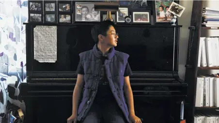  ?? Photos by Manjula Varghese / The Chronicle ?? Twelve-year-old classical pianist Christophe­r Nguyen sits by his favorite piano, above, and plays at the Lodge in Alameda, below.