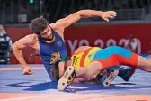  ??  ?? GET A GRIP: Wrestler Ravi Dahiya (left) turned the tables on his opponent after trailing badly to win the 57kg semifinal botu and assure India of a fourth medal from the Tokyo Olympics.