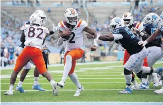  ?? ROBERT WILLETT/ASSOCIATED PRESS ?? Hokies QB Hendon Hooker, center, who played his first game of the season at UNC, played the entire second half and completed 7 of 13 passes for 136 yards and two touchdowns. He will make his first start of the year tonight.