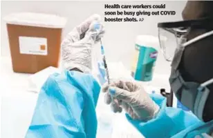  ?? AP ?? Health care workers could soon be busy giving out COVID booster shots.