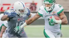  ?? PETER MCCABE/THE CANADIAN PRESS ?? The Saskatchew­an Roughrider­s’ Marcus Thigpen, right, dropped a big pass in the fourth quarter, but made amends with a key run in Sunday’s 34-29 win over the Montreal Alouettes.