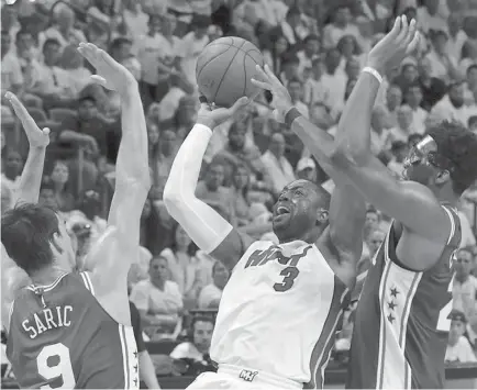  ?? AP Photo ?? FINAL DANCE. Miami Heat guard Dwyane Wade (3) shoots and scores against the Philadelph­ia 76ers during a first-round NBA basketball playoff series in Miami. Wade is coming back to the Miami Heat for a 16th and final NBA season.