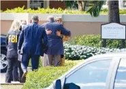  ?? AP PHOTO/MARTA LAVANDIER ?? Law enforcemen­t officers work at the scene of a shooting involving several FBI personnel serving a search warrant on Tuesday in Sunrise, Fla. Two FBI agents were fatally shot and three wounded. The suspect also ended up dead.