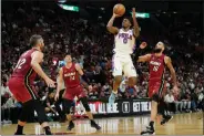  ?? LYNNE SLADKY - THE ASSOCIATED PRESS ?? Sixers guard Tyrese Maxey shoots as Miami Heat forward Kevin Love, guard Tyler Herro (14) and forward Caleb Martin (16) defend during the first half Monday.