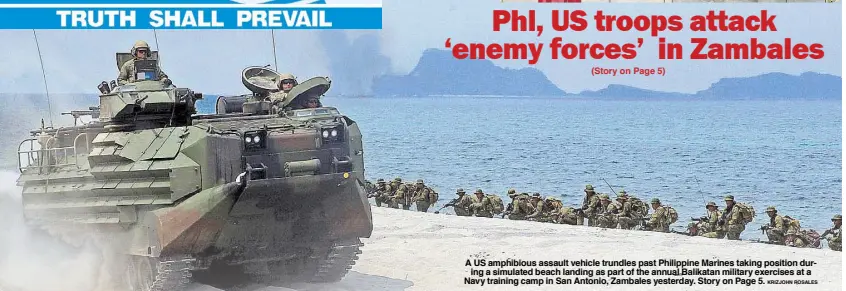  ?? KRIZJOHN ROSALES ?? A US amphibious assault vehicle trundles past Philippine Marines taking position during a simulated beach landing as part of the annual Balikatan military exercises at a Navy training camp in San Antonio, Zambales yesterday. Story on Page 5.