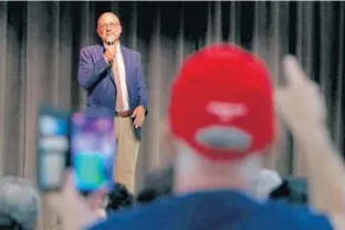  ?? JOHN MCCALL/SUN SENTINEL ?? Congressma­n Ted Deutch listens on Wednesday as President Donald Trump supporter Andrew Brett shouts during a town hall in Pompano Beach.