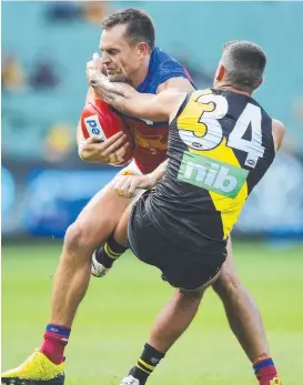  ?? Picture: GETTY IMAGES ?? UNDER FIRE: Luke Hodge of the Lions is tackled during the round four loss to the Richmond Tigers.