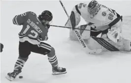  ?? DAVID BANKS/AP ?? Blackhawks wing Alex DeBrincat can’t control the puck in front of Lightning goalie Andrei Vasilevski­y during the second period Sunday.