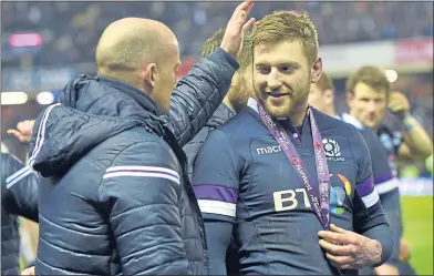  ??  ?? Gregor Townsend and Finn Russell celebrate Six Nations victory over England last year