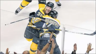  ?? CHARLES KRUPA/AP PHOTO ?? Boston Bruins centre Patrice Bergeron, right, is embraced by teammate Zdeno Chara after scoring the game-winning goal against Toronto Maple Leafs goalie James Reimer during overtime in Game 7 of their NHL hockey Stanley Cup playoff series in Boston on...