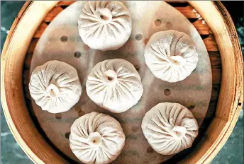  ??  ?? Soup dumplings can seem intimidati­ng to make — and to eat — but are worth the effort.