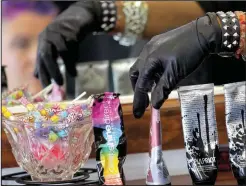  ?? Arkansas Democrat-Gazette/JOHN SYKES JR. ?? Hairdresse­r Stacie Mack reaches for tubes of hair color to use on client Andi Stracner at H2O Hair + Color in Little Rock. Stracner is among a growing number of women who opt for hair colors that are far from any human hair colors found in nature.