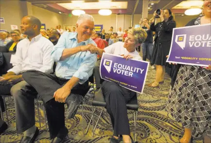  ?? Richard Brian ?? Las Vegas Review-journal @vegasphoto­graph Democratic gubernator­ial candidates Steve Sisolak, second left, and Chris Giunchigli­ani shake hands Monday during a Get Out the Vote rally hosted by the Human Rights Campaign at The Gay and Lesbian Community Center of Southern Nevada.