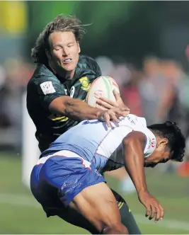  ?? Picture: Getty Images ?? COLLISION. Blitzbok Werner Kok is tackled by Tila Mealoi of Samoa during their match on the first day of the Dubai Sevens yesterday.