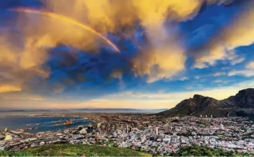  ??  ?? Rainbow over Cape Town, South Africa. South Africa is one of the most industrial­ized countries in Africa and an upper-middle-income economy according to the World Bank. VCG