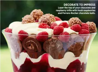  ??  ?? Layer the top of your chocolate and raspberry trifle with fresh raspberrie­s and Ferrero Rocher chocolate balls.
