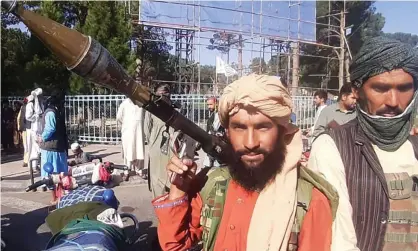  ?? Photograph: AFP/Getty Images ?? A Taliban fighter, armed with a rocket-propelled grenade, enters Herat, Afghanista­n’s third biggest city.