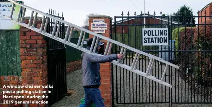  ??  ?? A window cleaner walks past a polling station in Hartlepool during the 2019 general election