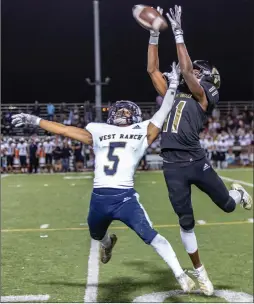  ?? Cory Rubin/The Signal ?? Golden Valley junior Mekhi Newton and West Ranch senior Dominik Martinez battle for a ball in the air during the Foothill League game Friday.