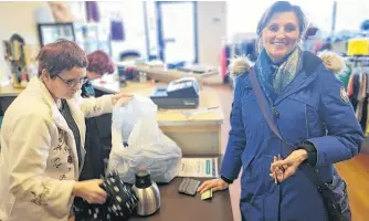  ?? ANDREW WATERMAN/THE TELEGRAM ?? Jacinta Mackey Graham (right) is a regular customer at Take Two and says the recent break and enter is, unfortunat­ely, a sign of the times.