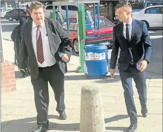  ?? Picture: KATHRYN KIMBERLEY ?? POWER WALKING: Advocate Terry Price and his client William Taute, 28, outside the Port Elizabeth Regional Court yesterday