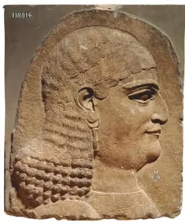  ??  ?? Fragment of a wall panel showing the head of a eunuch, 710BC– 705BC. Hairstyles were a way of indicating position in society