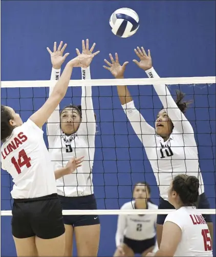  ?? The Maui News / MATTHEW THAYER photo ?? Sofia Stupplebee­n and Hoala Alapai of Kamehameha Schools Maui go up to block a shot by Lahainalun­a’s Alana Koa during the first set of the Warriors’ 17-25, 26-24, 25-22, 25-15 victory over the Lunas on Thursday night at Kaulaheanu­iokamoku Gym.