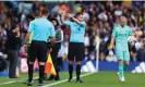  ?? Barratt/AMA/Getty Images ?? The referee, Chris Kavanagh, instructs both teams to leave the field after a power cut at Elland Road. Photograph: Robbie Jay