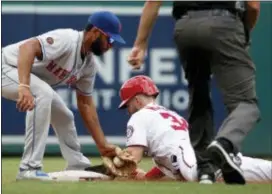  ?? THE ASSOCIATED PRESS ?? Nationals’ Bryce Harper safely steals second base as Mets shortstop Amed Rosario can’t make the tag in time during the first inning of Wednesday’s game.