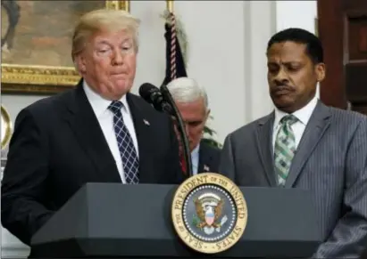  ?? ASSOCIATED PRESS ?? President Donald Trump pauses as he speaks during an event to honor Dr. Martin Luther King Jr., in the Roosevelt Room of the White House. With Trump are Vice President Mike Pence, and Isaac Newton Farris Jr., nephew of Martin Luther King Jr., right.